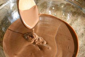 Why is it necessary to temper some kinds of chocolate?