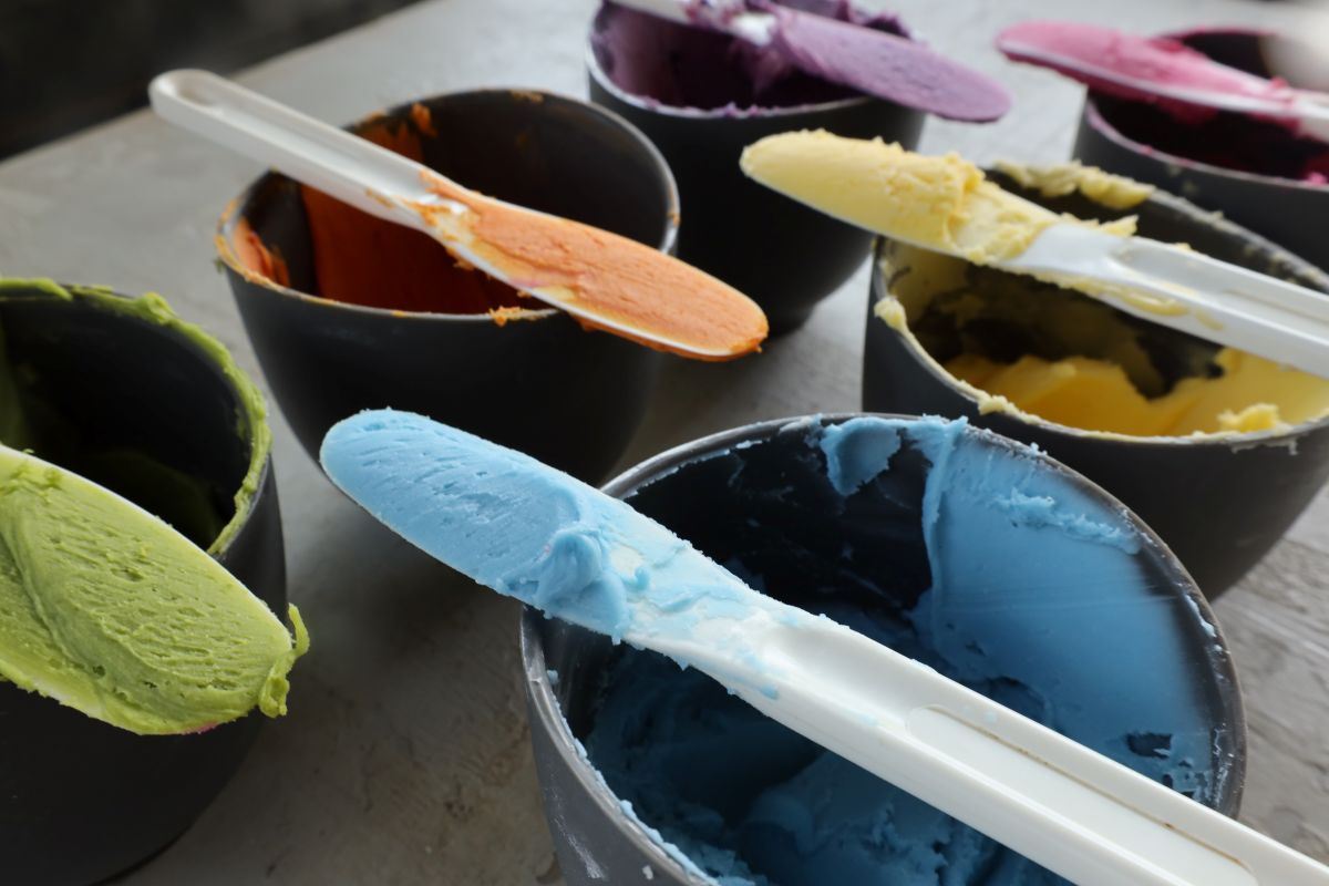 Brightly colored buttercream frosting in multiple shades demonstrating natural food coloring used in baking