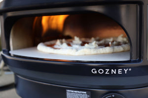 Backyard outdoor pizza oven cooking Neapolitan-style pizza with bubbling mozzarella and crispy crust