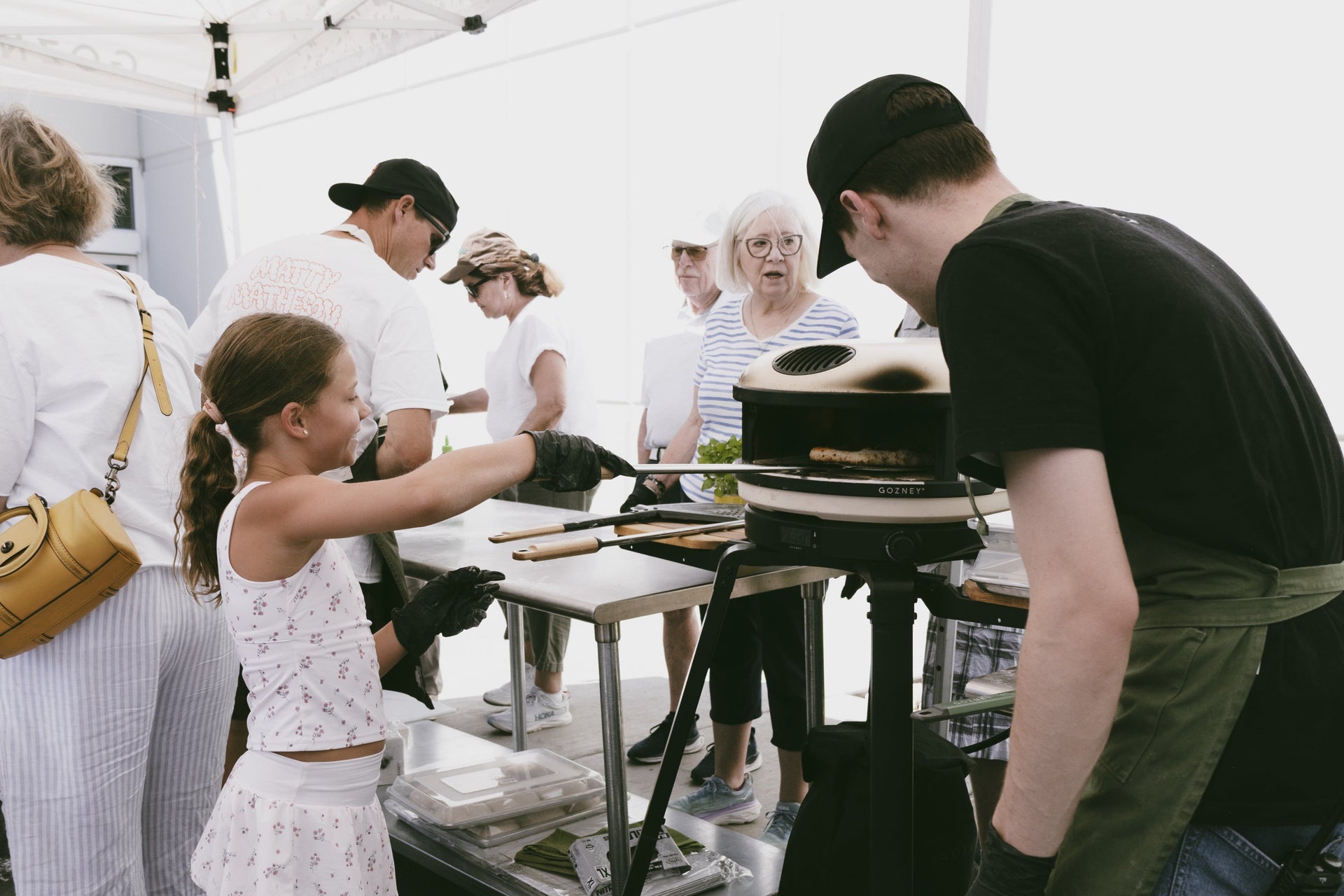 guests gather around Gozney pizza ovens during the Gozney X Gygi outdoor cooking event in Salt Lake City