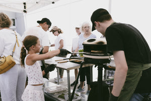 guests gather around Gozney pizza ovens during the Gozney X Gygi outdoor cooking event in Salt Lake City