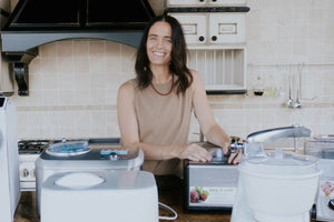 Person testing different ice cream machines and ice cream makers in a kitchen. 