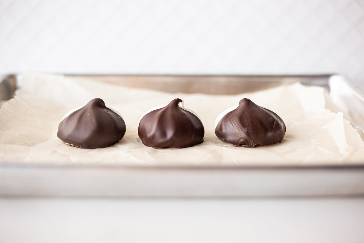 Shiny homemade chocolate pieces with a smooth finish and crisp edges after successful tempering.