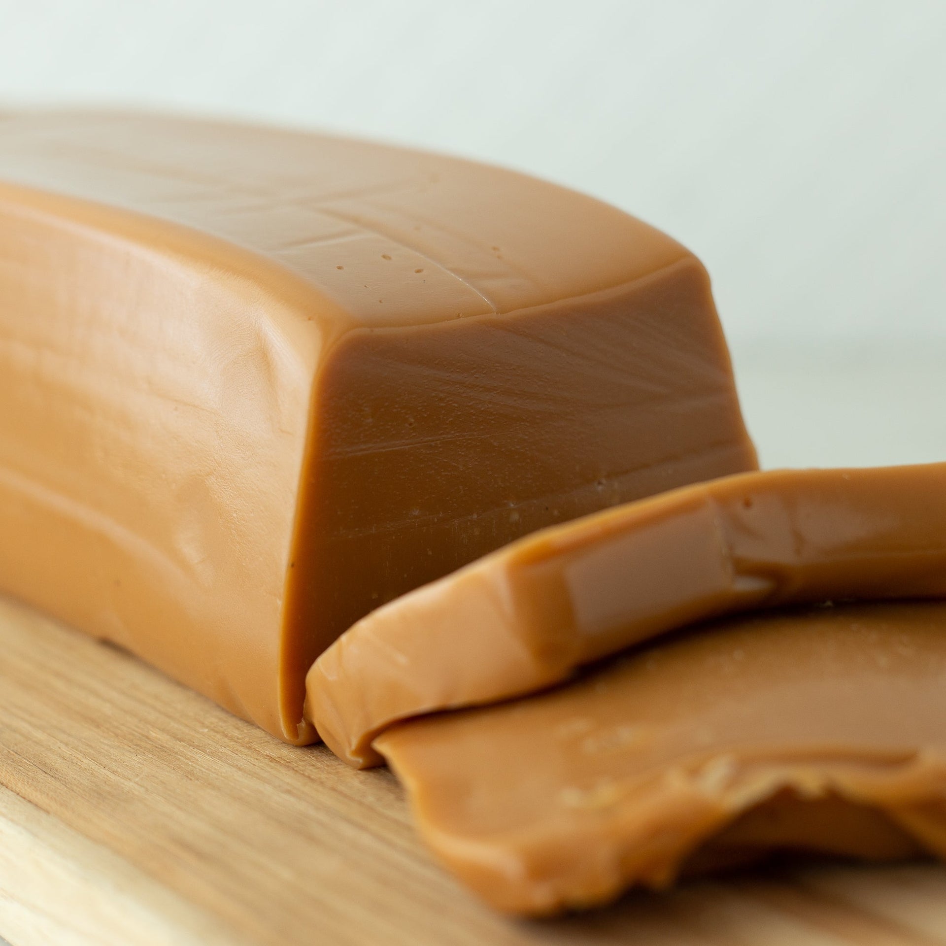 block of Peter's Caramel sliced on a cutting board