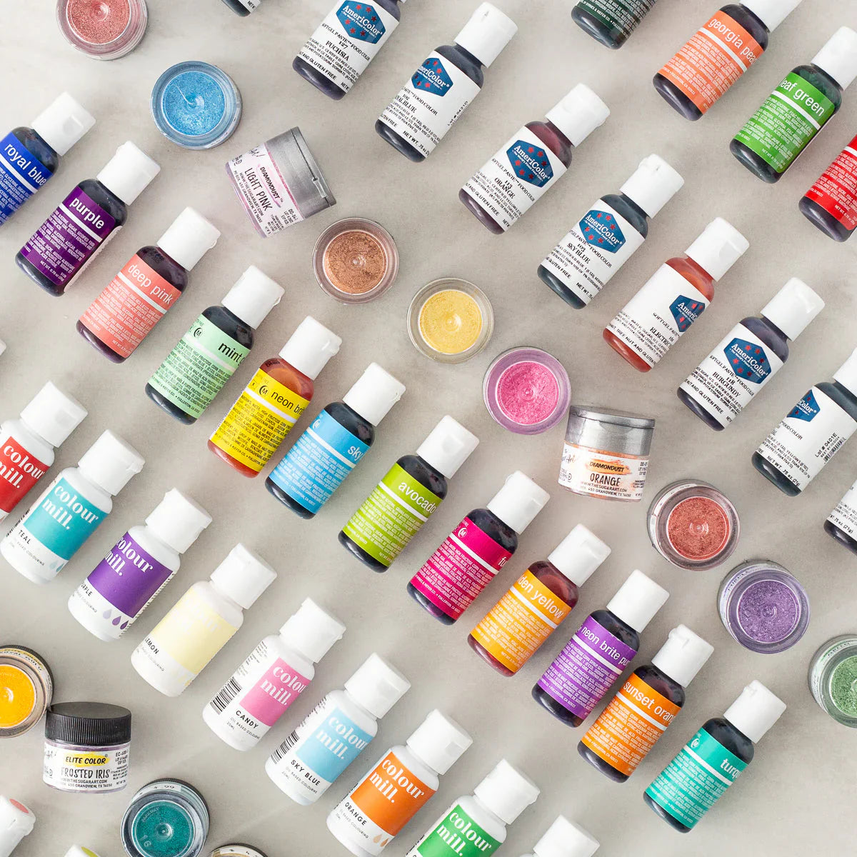 different types of food coloring—gel, powder, and oil-based—displayed across a baking surface