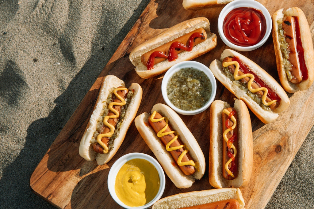 Perfectly grilled hot dog in a toasted bun topped with mustard, ketchup, and relish
