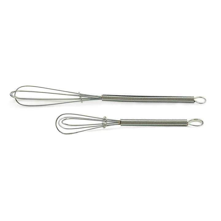 Two mini metal whisks on a white background