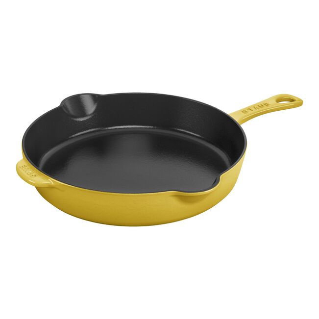 Yellow cast iron skillet on a white background