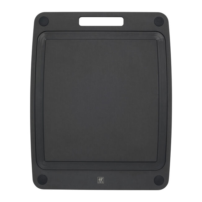 Black rectangular cutting board with deep juice groove and a handle on a white background