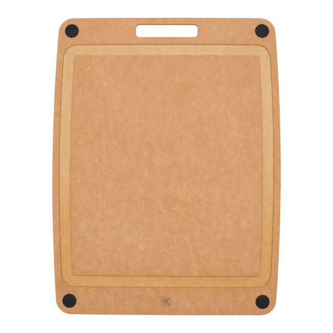 Brown cutting board with black corners and deep juice groove on a white background
