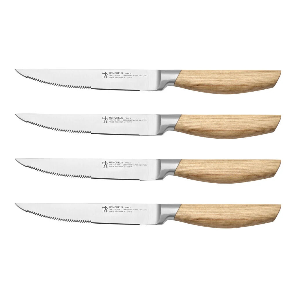 Set of four steak knives with wooden handles on a white background