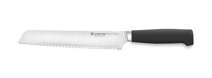 Bread knife with black handle on a white background