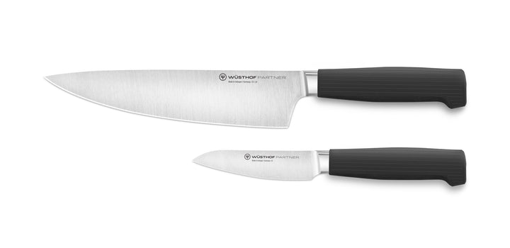 Two Wüsthof knives with black handles on a white background