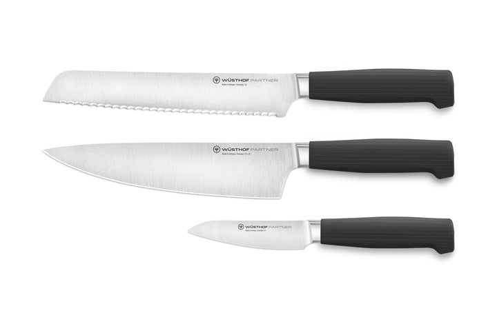 Set of three knives with black handles on a white background