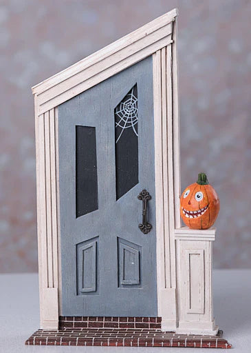 Decorative Halloween door with a pumpkin on a gray background