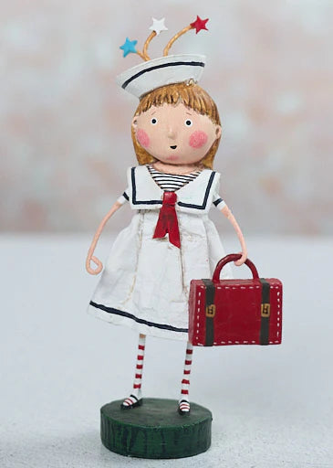 Decorative figurine of a girl in a sailor outfit with a red suitcase on a white background