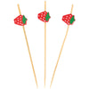 Three wooden toothpicks with strawberry-shaped ends on a white background