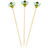 Three wooden skewers with bee-shaped ends on a white background