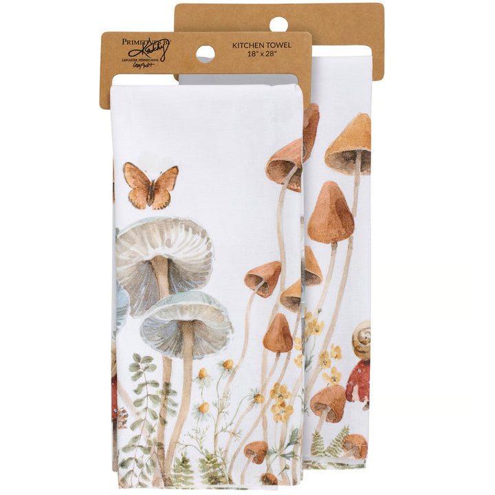 Two kitchen towels with nature-themed designs in packaging on a white background