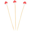 Three wooden skewers with mushroom-shaped ends on a white background