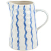 Ceramic pitcher with blue wavy patterns on a white background
