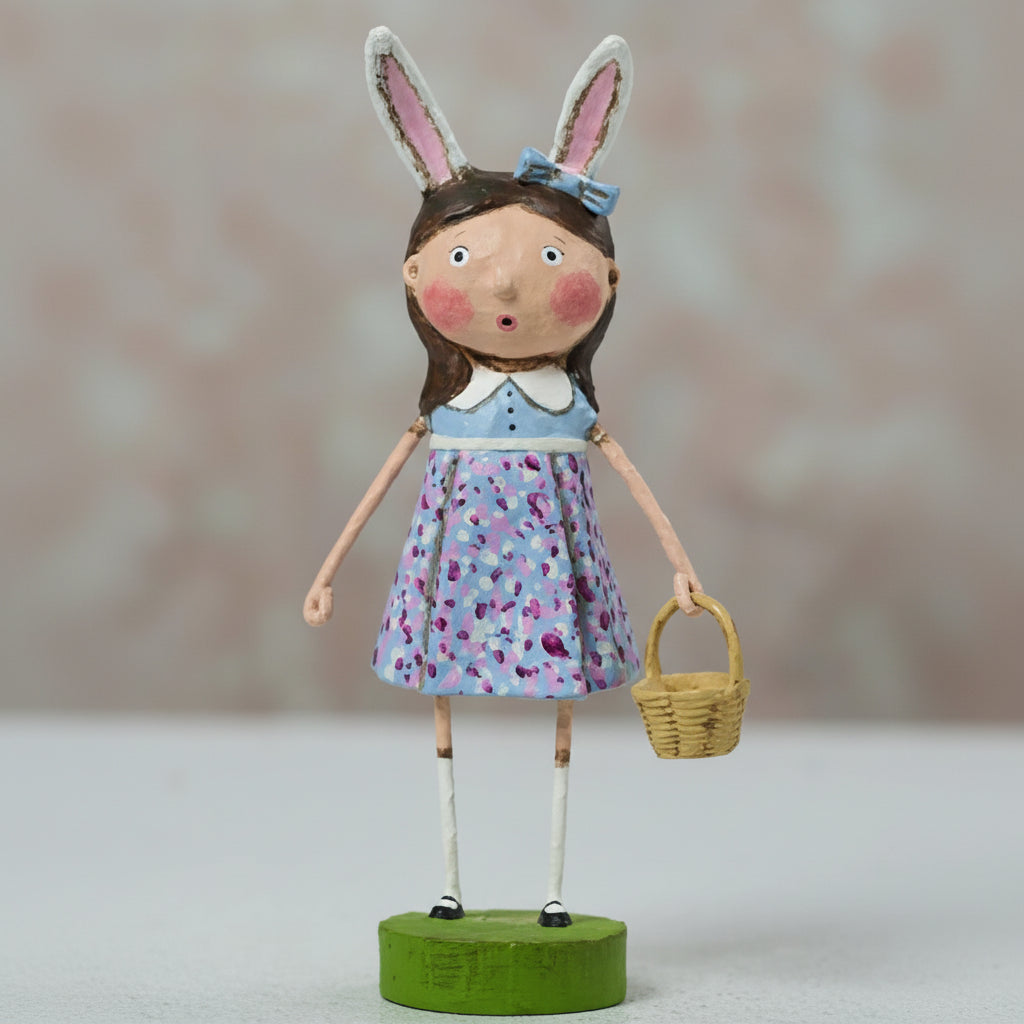 Doll with rabbit ears holding a basket on a neutral background