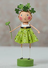 Decorative figurine of a girl in a green dress with shamrock accessories on a neutral background