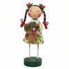 Decorative figurine of a girl holding a pot of strawberries, wearing a green dress adorned with strawberries; her hair is styled in braids with bows made of strawberries; on a white background.