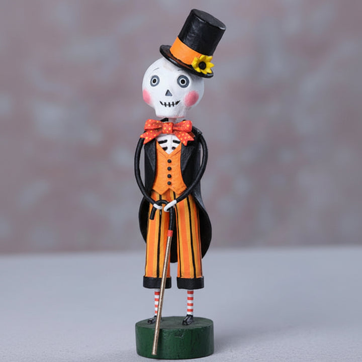 Decorative figure of a skeleton in a top hat and suit on a gray background