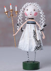 Artistic doll with white hair, white dress, and striped shoes holding a candlestick on a gray background