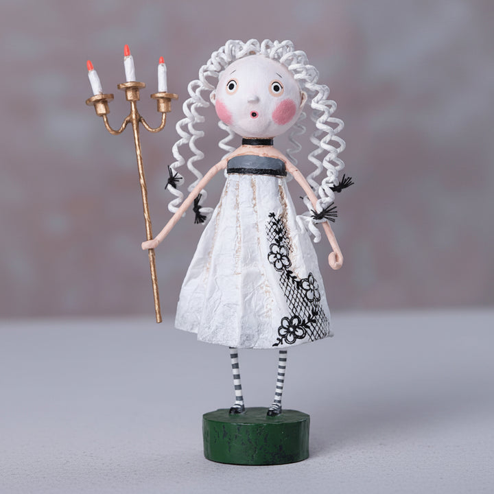 Artistic doll with white hair, white dress, and striped shoes holding a candlestick on a gray background