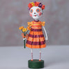 Decorative figure with a colorful dress and floral headpiece on a white background