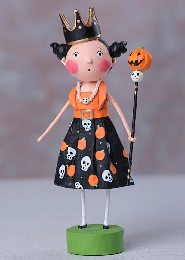 Halloween-themed figurine with a black dress featuring pumpkins and skulls, an orange top, and a crown.