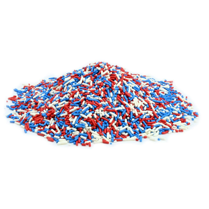 Pile of red, white, and blue sprinkles on a white background