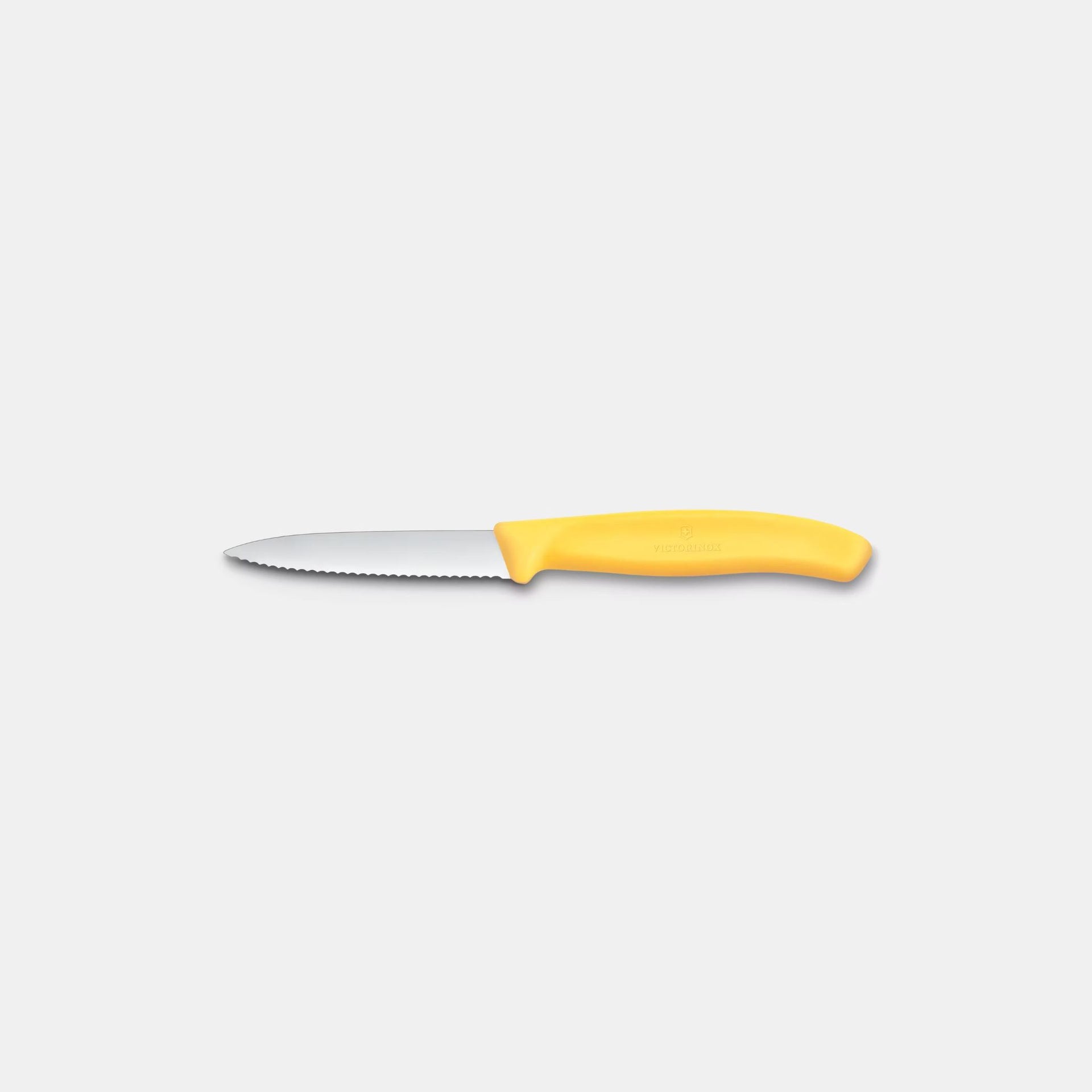 Paring knife with a yellow handle on a white background