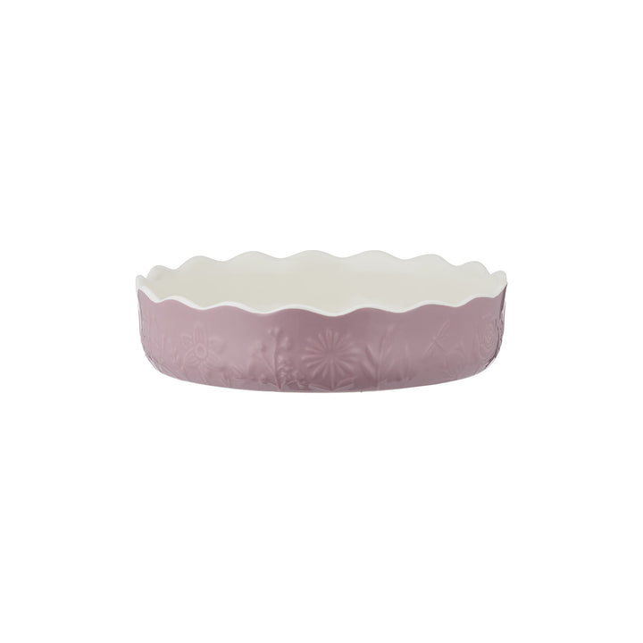 Purple pie dish with floral design on a white background