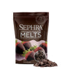 A bag of Sephra Dark Chocolate Flavors Melts, with a small pile of chocolate melts displayed in front on a white background.