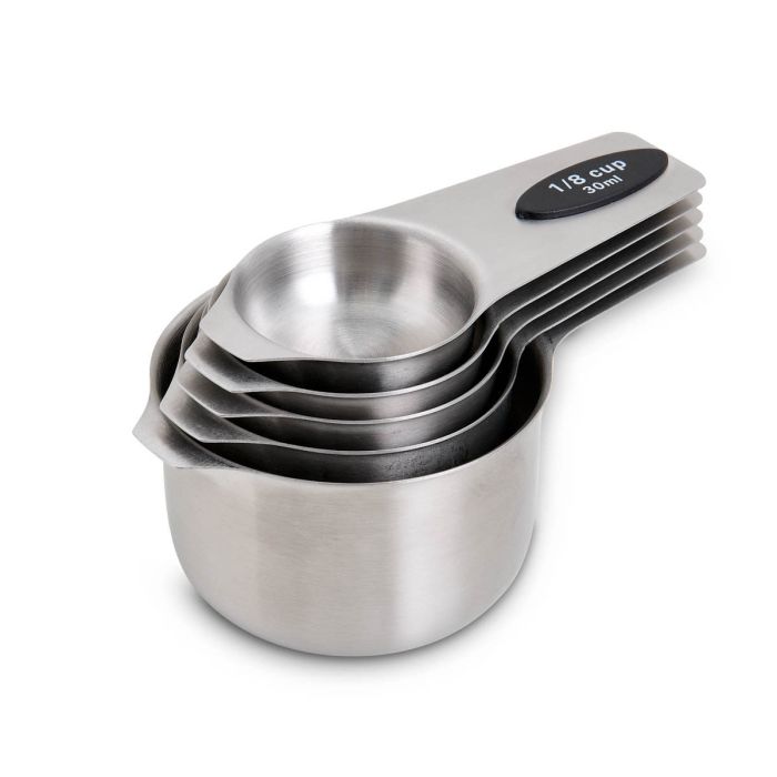 Set of stainless steel measuring cups on a white background