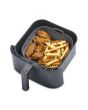 Air fryer basket with food on a white background