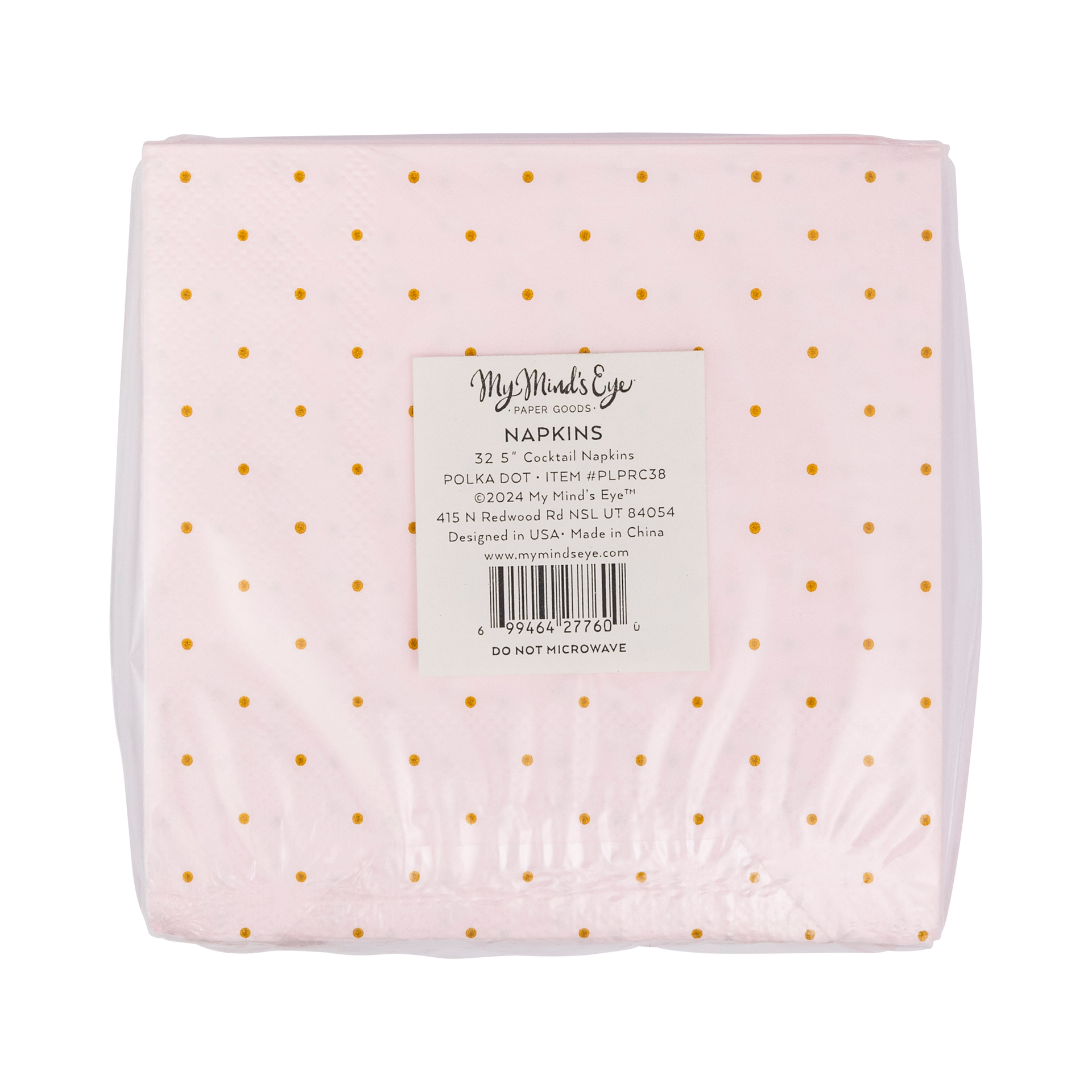 Packaged napkins with gold polka dots on a light pink background, featuring a label with text.