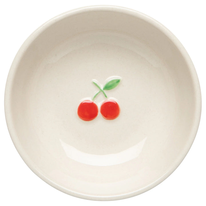White stoneware bowl with red cherries on a white background
