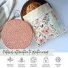 Floral-patterned beeswax bread bag with a polka dot bowl cover on a light background