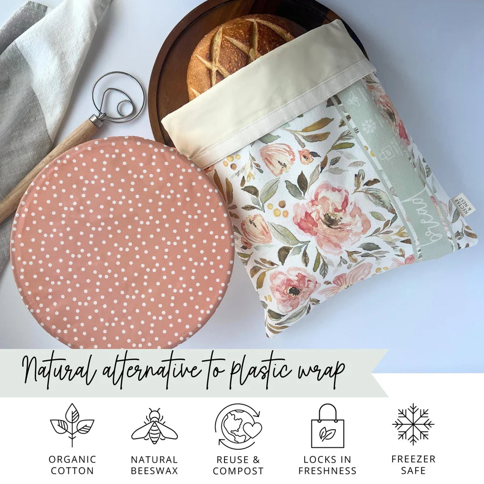 Floral-patterned beeswax bread bag with a polka dot bowl cover on a light background
