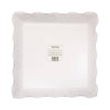 Bottom view of paper plates with scalloped edges on a white background