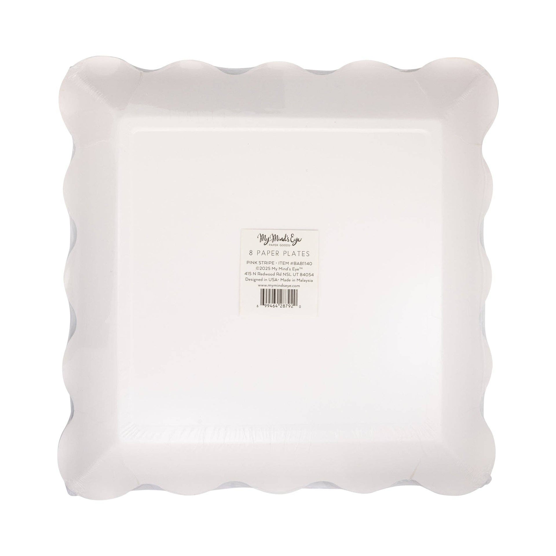 Bottom view of paper plates with scalloped edges on a white background