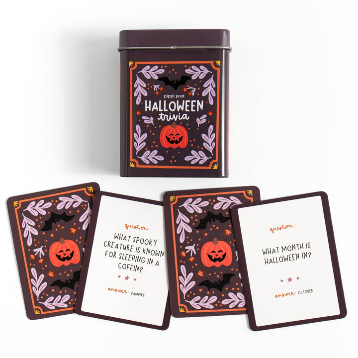 Halloween trivia cards with a decorative tin container on a white background