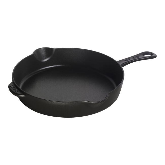 Black cast iron skillet on a white background