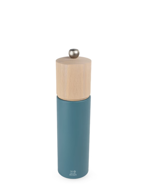 Blue pepper grinder with wooden top on a white background