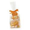 Bag of candy corn marshmallows with an orange ribbon and label on a white background
