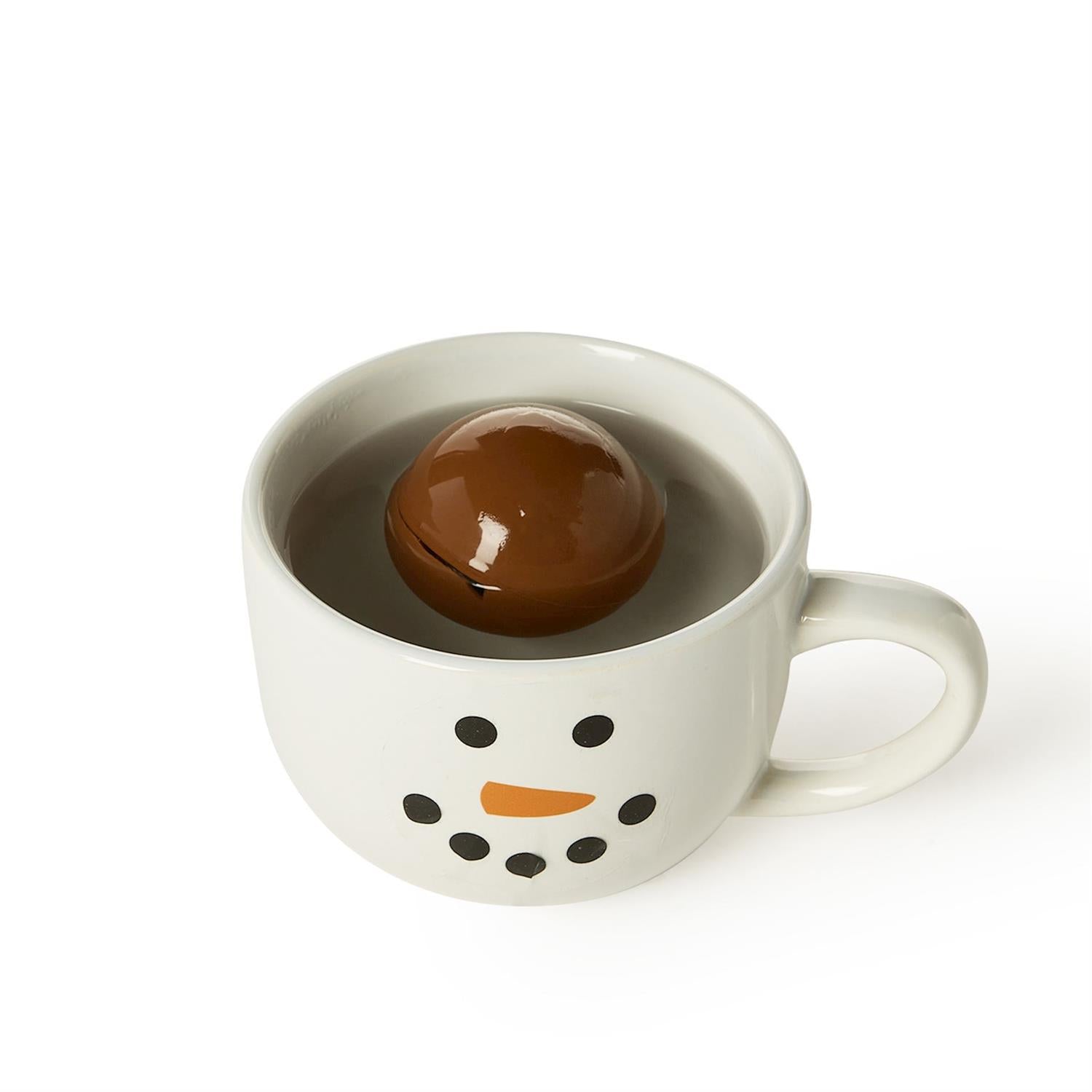 Snowman-shaped mug with a hot chocolate bomb inside on a white background